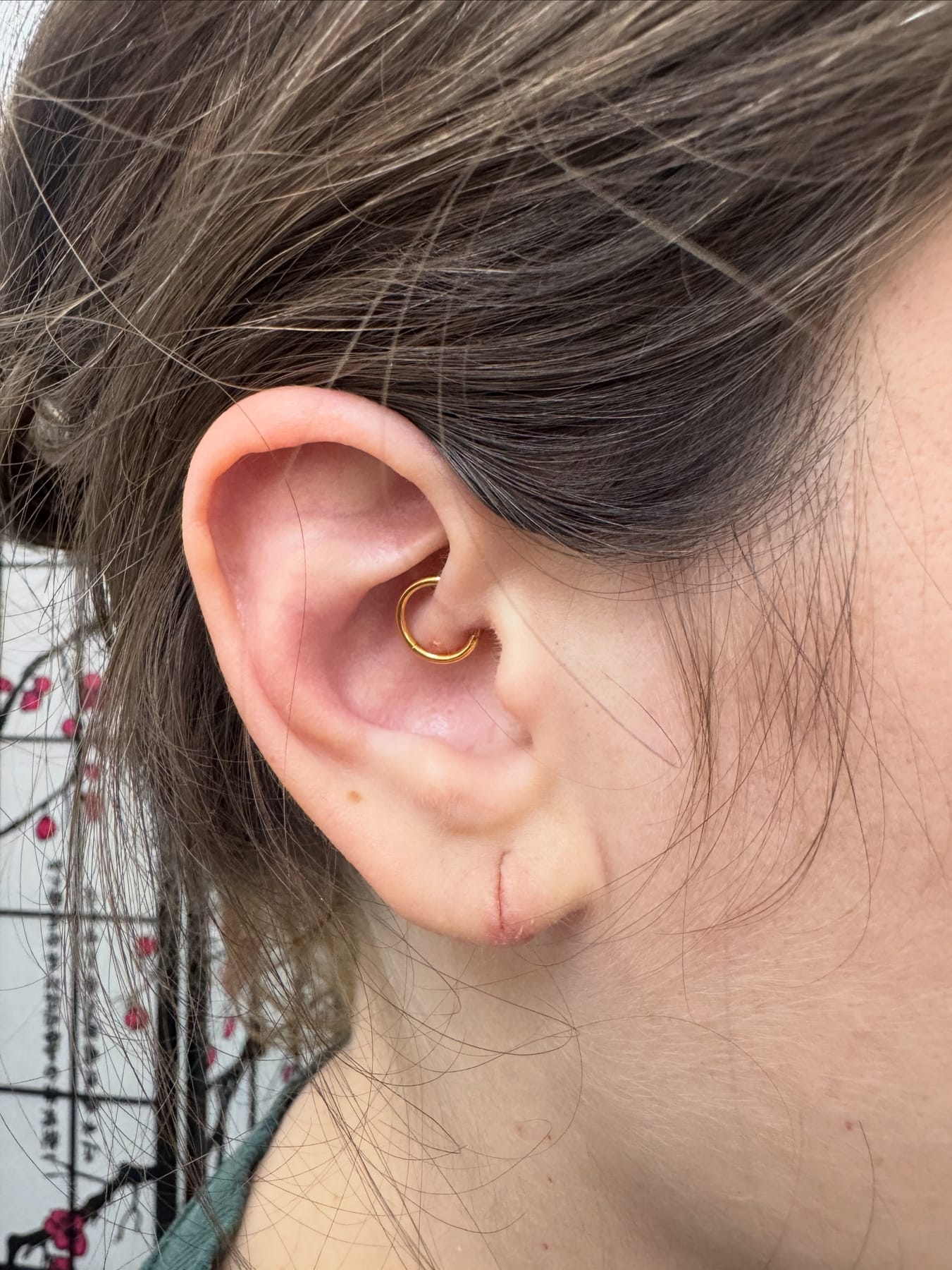 Side portrait with gold ear stud
